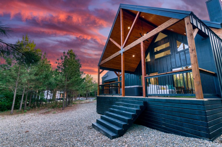 Timber porch and exterior at dusk — Blue Spruce · Broken Bow