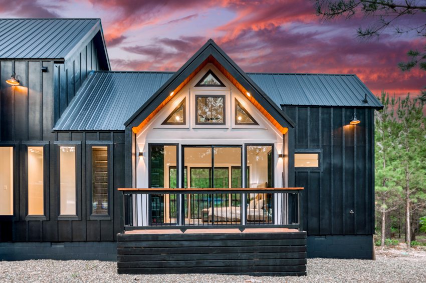 Glazed cabin exterior at twilight — Blue Spruce · Broken Bow