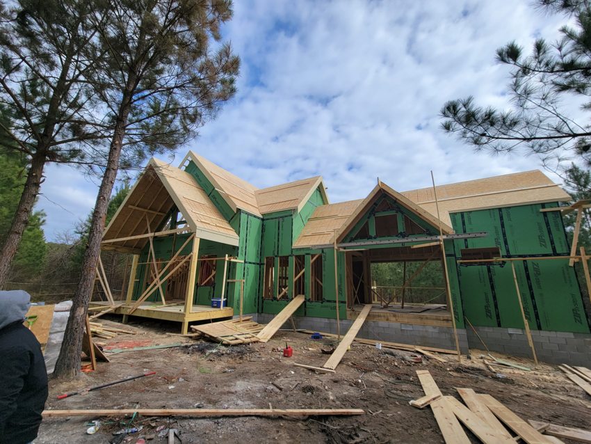 Cabin framing and enclosure in the woods — Broken Bow · Construction