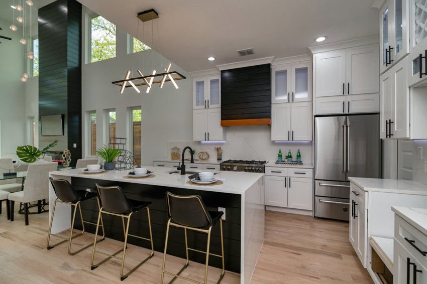 Kitchen with island and modern lighting — W. University · Dallas