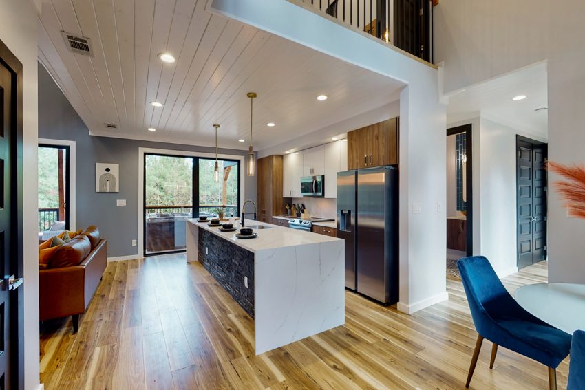 Kitchen and living space beneath timber ceilings — Blue Spruce · Broken Bow