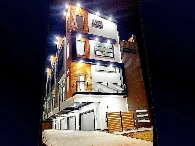 Delano townhome facade illuminated at night