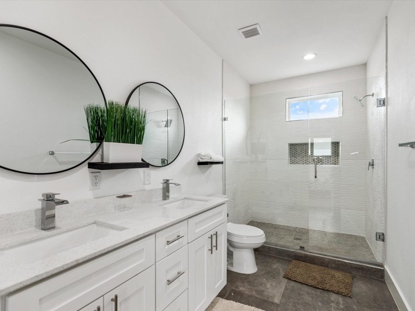 Bathroom with dual vanity and glass shower — Delano · Dallas