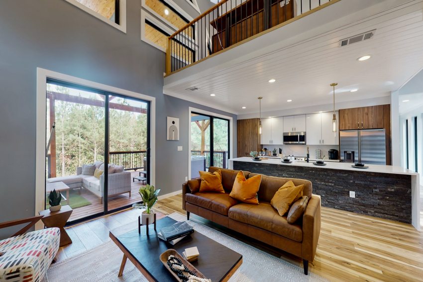Open living and kitchen beneath vaulted ceiling — Blue Spruce · Broken Bow